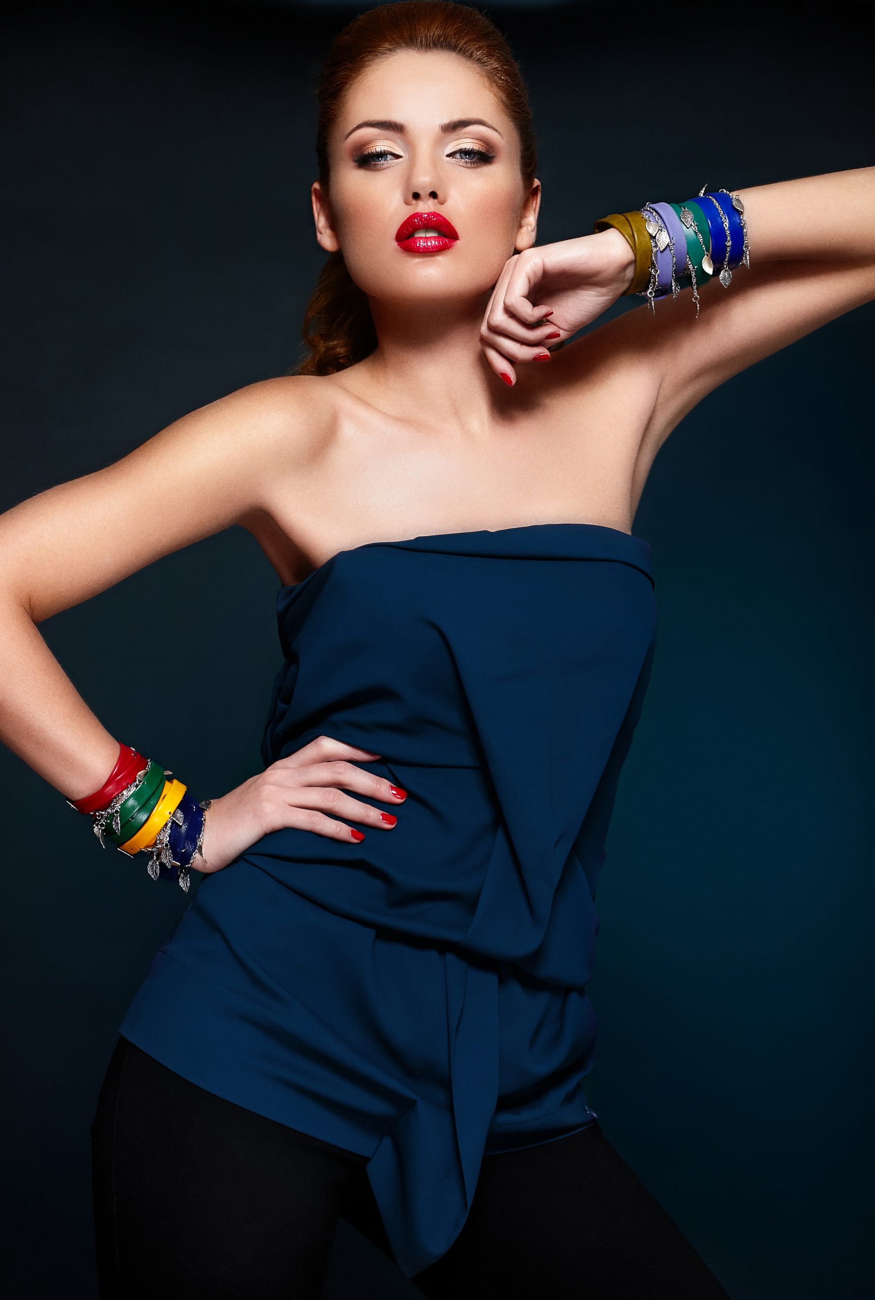 High fashion look.glamor closeup portrait of beautiful sexy stylish blond Caucasian young woman model with bright makeup, with red lips, with perfect clean skin with colorful accessories in blue cloth